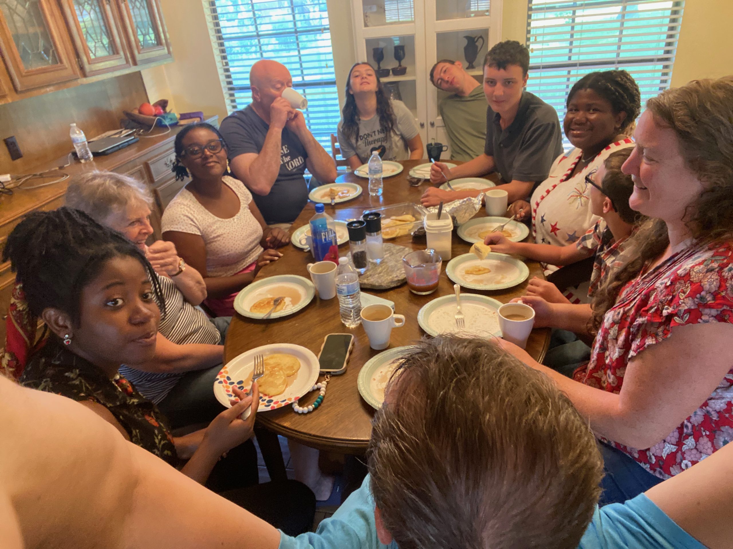 Bible college students and friends sharing fellowship around a meal